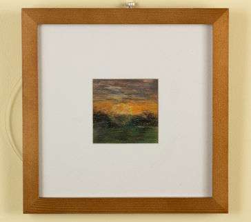 sun rising over grassy field. Ring of light shining against both the field and the sky. Sky is bright ornge that fades in cloudy grays